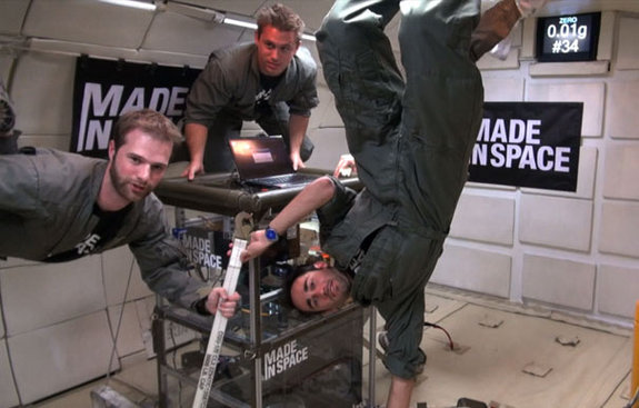 Made in Space team members Adam Ellsworth, Brinson White and Jason Dunn wave to the camera while testing multiple 3D printers in zero-gravity. 