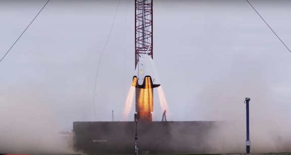 SpaceX's Dragon 2 crew capsule prototype hovers during a rocket motor test in November 2015 in this still from a SpaceX video released in January 2016. 