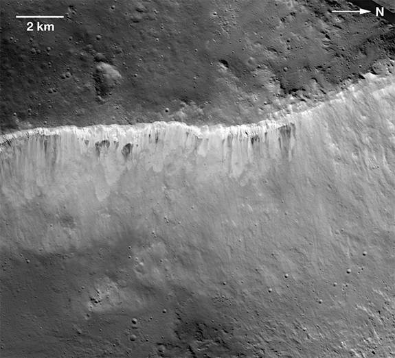 There’s a sharp contrast between bright and dark material for the crater Marcia, viewed by the Dawn spacecraft. The bright material is believed to be Vesta’s original stuff, while the darker material is thought to come from collisions with carbon-rich space rocks.