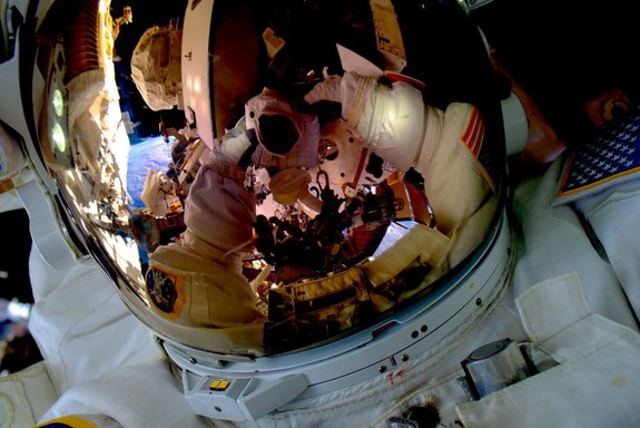 Kelly snaps one of the coolest selfies ever taken—himself suited up for a spacewalk. 