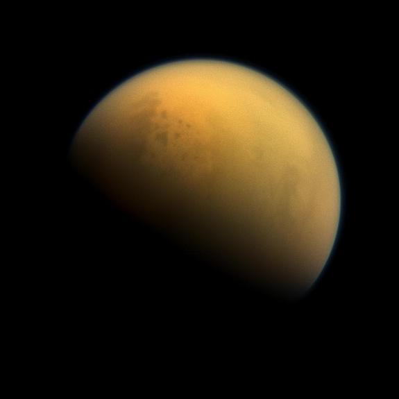 NASA’s Cassini spacecraft captured this image of Saturn's largest moon Titan, which has a thick atmosphere and is home to vast lakes of liquid methane. These lakes are visible in this image as darker blotches in the moon's upper right. 