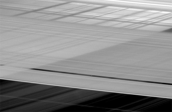 Saturn's Crisscrossed Rings Hide Tiny Moon