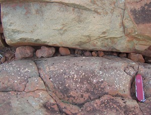 Gas bubbles that formed as this lava cooled (on the shore of Australia's Beasley River), some 2.7 billion years ago, can reveal the pressure of the ancient atmosphere. (Bubbles show up as white spots.)