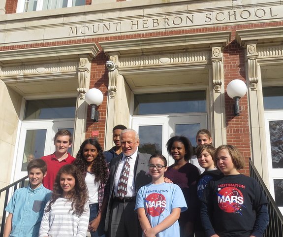 Apollo 11 moonwalker Buzz Aldrin poses with students on the stairs of the former Mount Hebron Middle School in Montclair, New Jersey, in October 2015. The school is being renamed the Buzz Aldrin Middle School, after the Montclair-born astronaut. 