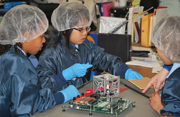 Grade-school students from St. Thomas More Cathedral School in Arlington, Virginia, designed and built a miniature satellite that deployed from the International Space Station on May 16, 2016.