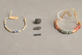 Ancient iron beads (center) excavated from an Egyptian tomb in 1911 were made from iron meteorites. 