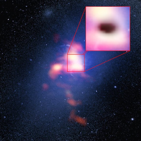 This composite image of Abell 2957 includes a background image taken by the Hubble Space Telescope and a red foreground image from the ALMA radio telescope showing the distribution of carbon monoxide gas in and around the Abell 2597 Brightest Cluster Galaxy. The pull-out box shows the "shadow" of the galaxy's supermassive black hole, which appears to be eating cold clouds of molecular gas.