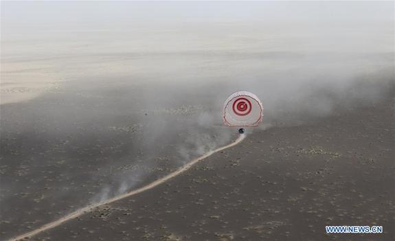 A prototype crew capsule that launched on the maiden (uncrewed) flight of China's Long March 7 rocket on June 25, 2016 touches down in north China's Inner Mongolia Autonomous Region on June 26.