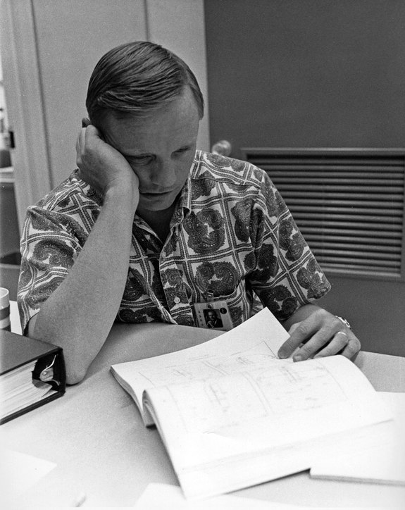 Neil Armstrong is seen reviewing the Apollo 11 flight plan two days before launching on the first moon landing mission on July 16, 1969. 