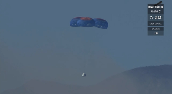 Blue Origin's New Shepard crew capsule floats back to Earth under its main parachutes after a dramatic in-flight launch abort test over West Texas on Oct. 5, 2016.